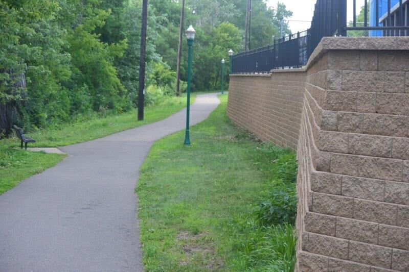 Converting an old warehouse into an office building in Hudson, Wis., required the excavation of a slope and the building of a retaining wall to create a much-needed parking lot and to limit stormwater runoff into the St. Croix River, a national scenic riverway, which runs parallel to the property on the other side of the paved trail.​ ​