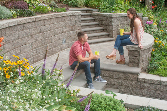 VERSA-LOK retaining walls in the hands of a skilled designer-installer turned the unruly slope into an attractive and comfortable outdoor space.